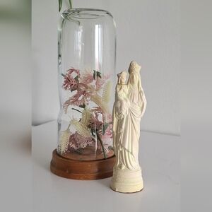 Antique fluorescent religious statuette in a glass dome